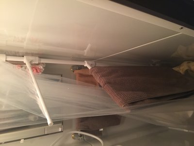 When the shower curtain is pushed all the way to the left it doesn't touch the caddy.