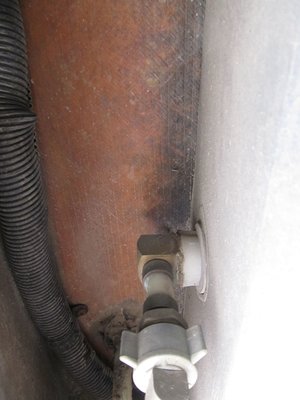 looking up at last bit of piping before it goes into black tank wall.jpg