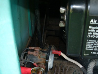 Fuel filter just barely apparent in area to rear and above bright red wire terminal